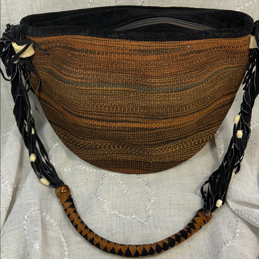 Handmade woven leather and bone shoulder basket bag